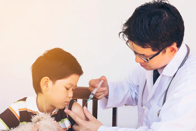 sick asian boy being treated by male doctor 1150 6247.jpg